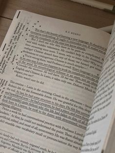 an open book sitting on top of a wooden table