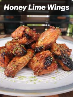 honey lime wings on a white plate with the words honey lime wings in front of it