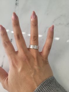 a woman's hand with two rings on it