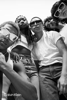 a group of young people are posing for the camera with sunglasses on their faces and one has his arm around the other's neck