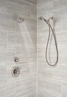 a shower head and hand shower in a bathroom