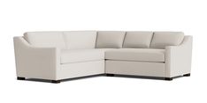 a white sectional couch with the corner section facing it's back and footrests