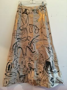 a metallic skirt with black and white drawings on it