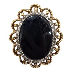 Circa 1980s goldtone oval smooth faux-onyx center with tiny round clear rhinestones surround brooch with security clasp and loop to be worn as a pendant. Measures: 1 3/8 inches long by 1 1/8 inches wide. Condition: Very good; a few of the tiny clear rhinestones have darkened, but they're so small it's not very noticeable. Georg Jensen, Gold Brooches, Pearl Brooch, Rhinestone Brooches, Vintage Costume Jewelry, Clear Rhinestones, Gold Finish, Matte Gold, 10k Gold