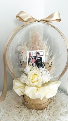 a vase filled with flowers sitting on top of a white fur covered floor next to a wall