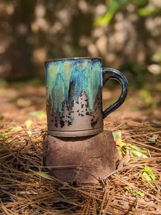 a coffee cup sitting on top of a wooden stump