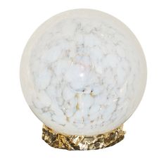 a white marble ball sitting on top of a metal stand with gold leaf accents and a golden base