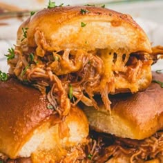 two pulled pork sandwiches stacked on top of each other