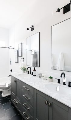 a bathroom with two sinks and mirrors in it