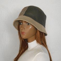 Size 57-58 cm  Women's bucket hat. This is a fashionable and stylish hat for the cold season. Winter hat with small brim. The women's hat is made of checkered fabric and monochrome brown fabric with a slight shiny effect.   Beautiful combination of colors - beige and brown.  Hat with warm lining.  Size 57-58 cm Brown Wide Brim Cloche Hat For Outdoor, Brown Brimmed Cloche Hat For Outdoor, Beige Cloche Hat With Short Brim For Outdoors, Trendy Brimmed Cloche Hat For Winter, Outdoor Wide Brim Cloche Hat, Green Cloche Hat For Winter, Trendy Brimmed Bucket Hat For Winter, Trendy Brimmed Winter Bucket Hat, Beige Bucket Hat With Short Brim For Fall