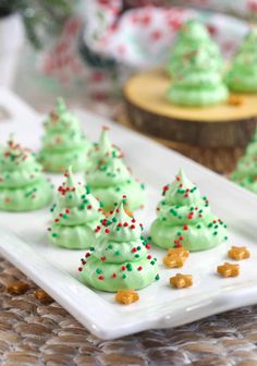 green frosted christmas trees on a white plate with gold and red sprinkles