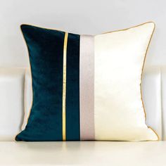 a blue and white pillow sitting on top of a table