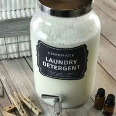 a bottle of laundry deterant sitting on top of a wooden table next to other items