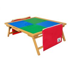 a child's folding table with two red and blue squares on the top, and one green square at the bottom