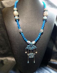 This necklace was created from new 5 mm color enhanced blue jade beads combined with an antique Chinese export enamel pendant and Chinese silver and enamel beads. It has a silver S clasp. The pendant is enameled on both sides. The necklace measures 22 inches long plus the 4.5 inch pendant. The design was influenced by dynastic Chinese court necklaces and it is an original one of a kind design. *Fine jewelry authenticated by a GIA Gemologist *FREE SHIPPING in USA with signature required for your Champagne Diamond Rings, Pebble Pendant, Jade Bead Necklace, Pendant Necklace Vintage, Antique Finds, Jade Crystal, Blue Jade, Vintage Beads Necklace, Enamel Beads