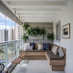 a living room filled with furniture and lots of windows next to a large window sill