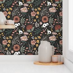 the wallpaper in this kitchen is very colorful and has flowers, leaves and plants on it