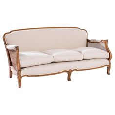 a white couch sitting on top of a wooden frame