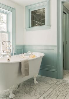 a white bath tub sitting next to a window