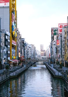 a river running through a city next to tall buildings