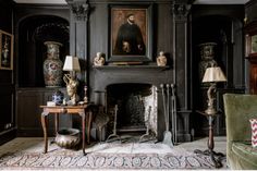 a living room filled with furniture and a painting on the wall above a fire place