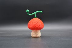 a small plastic toy with a brain on top