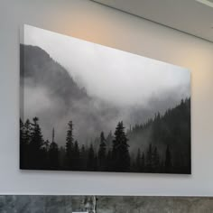 a bathroom sink sitting under a painting on the wall