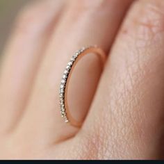 a woman's hand with a diamond ring on it