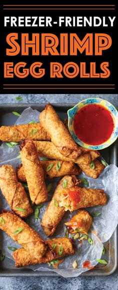 fried shrimp egg rolls with ketchup on the side and sauce in a bowl