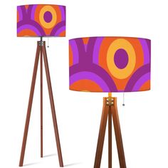 two floor lamps with different designs on them, one is orange and the other is purple