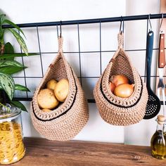 two baskets filled with potatoes hanging from hooks