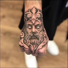 a man's hand with a tattoo on it