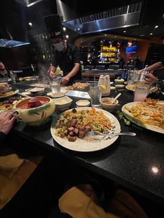 several plates of food on a table in a restaurant