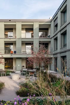 an apartment building with several balconies and plants