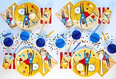 the plates are decorated with colorful paper decorations