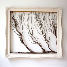 a white frame with some branches in it