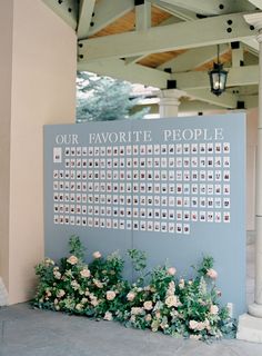 a sign with flowers on it in front of a building that says our favorite people