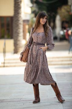 "Brown Long Puffed Sleeve Midi Floral Winter Dress, Buttoned Down Dress, Loose Boho Chic Urban Dress for Women This gorgeous floral dress features a high waistline, Pockets, puffed long sleeves, buttons all the way in the front, and an elastic band on the bust, for maximum flexibility, comfort, and perfect fitting to any body type. It is very flattering and lightweight, it offers a unique look, accentuating the waistline. it has an urban boho-chic look. Materials: Soft Rayon Colors:  Floral Brown, Also available in Green and in sleeveless version - https://etsy.me/3ueKliV SIZE: There are 4 sizes available - XS, SM, ML, XL (the hips is free size, not need to check) -  XS: Bust: up to 32.5\" / 83 cm Length: 43\" / 109 cm Sleeve length: 20\" / 51 cm SM: Bust: up to 34.5\" / 88 cm Length: 44\" Fall Boho V-neck Dress With Floral Print, Festival Boho Print Midi Dress With V-neck, Beach Tunic Dress, Floral Dress Winter, Bohemian Brown V-neck Boho Dress, Fall Boho Floral Print V-neck Dress, Bohemian Non-stretch Floral Print Dress, Urban Boho, Puffed Long Sleeves