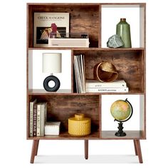 an open book shelf with books and other items on it, including a small globe