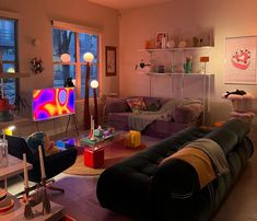 a living room filled with lots of furniture and colorful lights on the windows sill