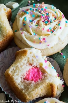 several cupcakes with white frosting and sprinkles