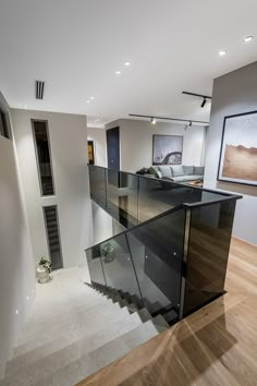 an open concept living room with stairs leading up to the second floor