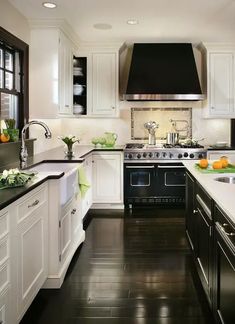 a kitchen with white cabinets and black counter tops is pictured in this image from the front view