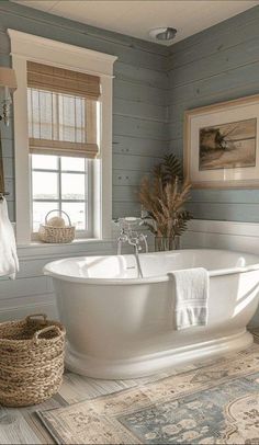 a white bath tub sitting inside of a bathroom next to a rug and window sill