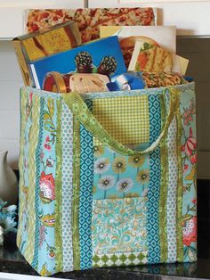 a bag filled with books and magazines on top of a counter