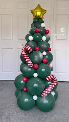 a christmas tree made out of balloons and candy canes