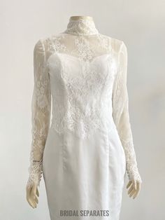 a white dress with lace on the neck and sleeves