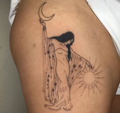 a woman with a moon and stars tattoo on her thigh