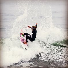 a person riding a surf board on a wave in the ocean with their arms out