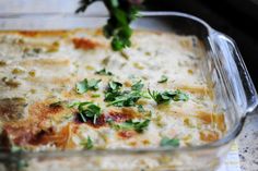 a casserole dish with cheese and herbs